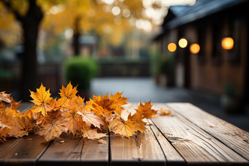 Wall Mural - Yellow maple leaves on a wooden table with a blurred bokeh background. Empty free space for product display