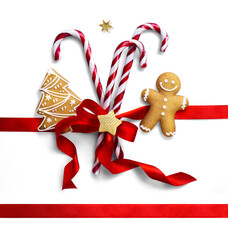 Wall Mural - christmas composition with isolated christmas sweet candy, ginger men and red silk ribbon on transpa