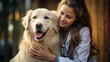 Young female veterinary doctor taking care of a golden retriever dog in her pet clinic, hugging the dog