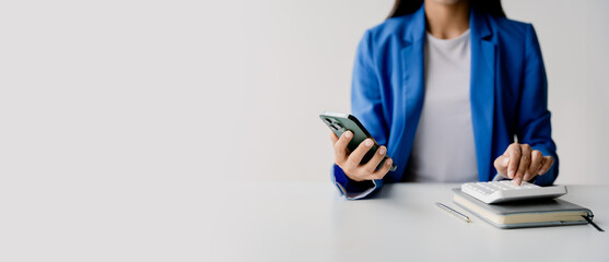 Wall Mural - portrait of woman working in finance using smartphone and calculator in modern office, preparing acc