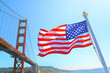 The US flag flown from cruise ship underneath there Golden Gate Bridge in San Francisco, CA