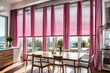 Gray roman shades and a pink curtain over large, glass windows in a modern kitchen and dining area with a wooden table and white chairs