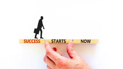 Wall Mural - Success starts now symbol. Concept word Success starts now on beautiful wooden block. Businessman hand. Beautiful white table background. Business motivational success starts now concept. Copy space.