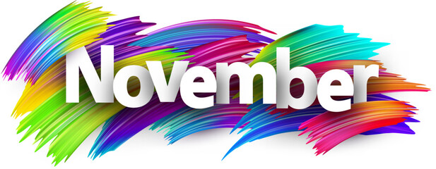 Canvas Print - November paper word sign with colorful spectrum paint brush strokes over white.