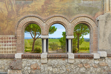 Sticker - Beautifully painted house facade with Romanesque windows. Depending on the requirements, a beautiful background, for example a Tuscany picture, can be mounted.