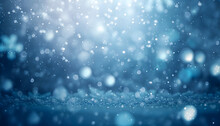 Winter Scene Of Snowflakes Falling With Sparkling Ice And Bokeh Light Particles On A Dreamy Blue Background. Room For Copy Space.