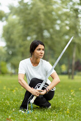 Caucasian man working out with Tai Chi sword in the morning at the park