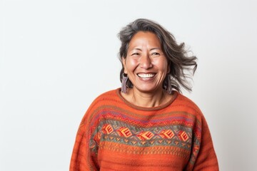 Canvas Print - Portrait photography of a happy Peruvian woman in her 50s wearing a cozy sweater against a white background