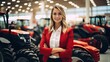 Female tractor salesperson stands in showroom and guarantees spare parts and service of agricultural machinery.
