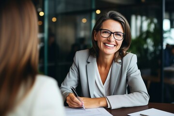 A smiling 45-year-old banker and a happy middle-aged business manager, both mature professionals, are seen in their office. The older, mature entrepreneur wears glasses