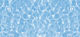 Defocus blurred transparent blue colored clear calm water surface texture with splashes reflection. Trendy abstract nature background. Water waves in sunlight with copy space. Blue watercolor shine.