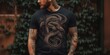 © Влада Яковенко - Men's black tee mockup on tattooed model