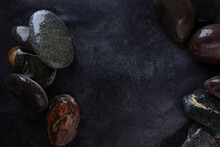 Dark Background With Sea Stones. Background For Designers. Wet Stones. He Was Lying Flat. View From Above. Flat Lay. Top View. Copy Space.