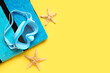 Leinwandbild Motiv Swimming mask, towel and starfish on yellow background