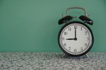 alarm clock on green background