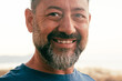 © simona - Close up portrait of happy man cheerful looking on camera. One adult mature male caucasian smile with confident and serene expression. White outdoor sky background. People and age happiness lifestyle