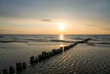 Fototapeta Morze - Sunset on the Baltic Sea in Poland. Landscape in the evening with setting sun by the sea.