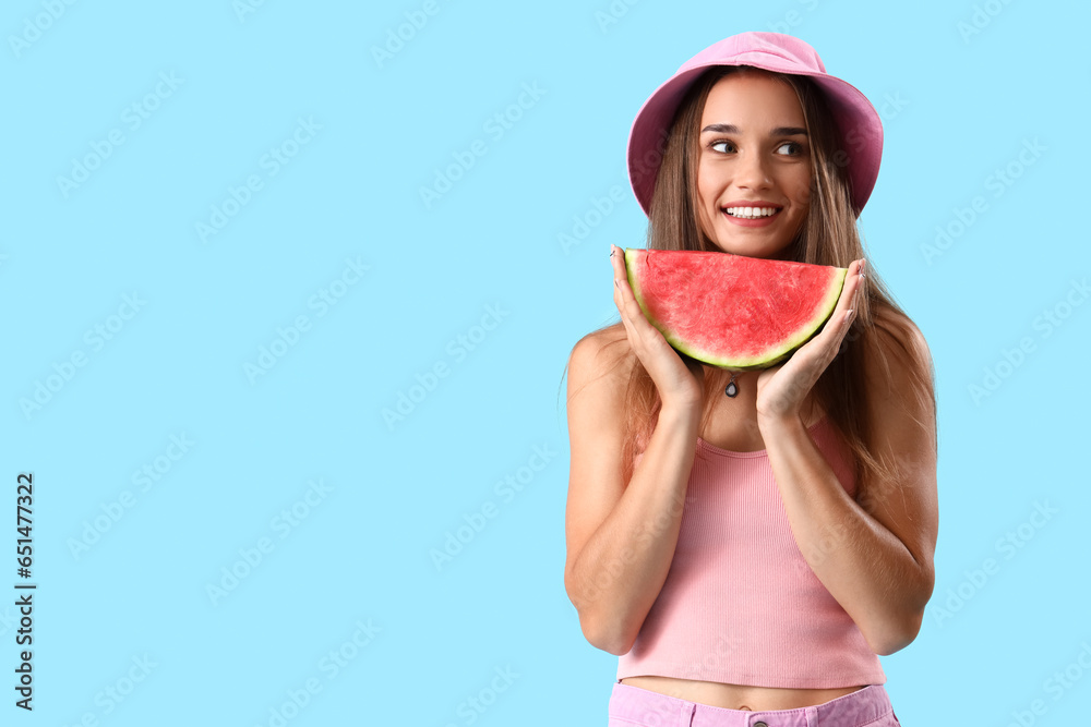 Young woman with fresh watermelon on blue background