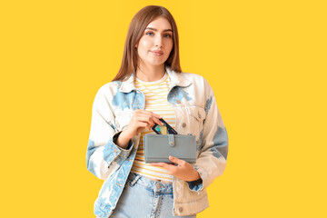 Sticker - Young woman with credit card and wallet on yellow background