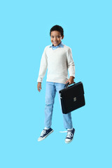 Sticker - African-American little boy with briefcase jumping on blue background