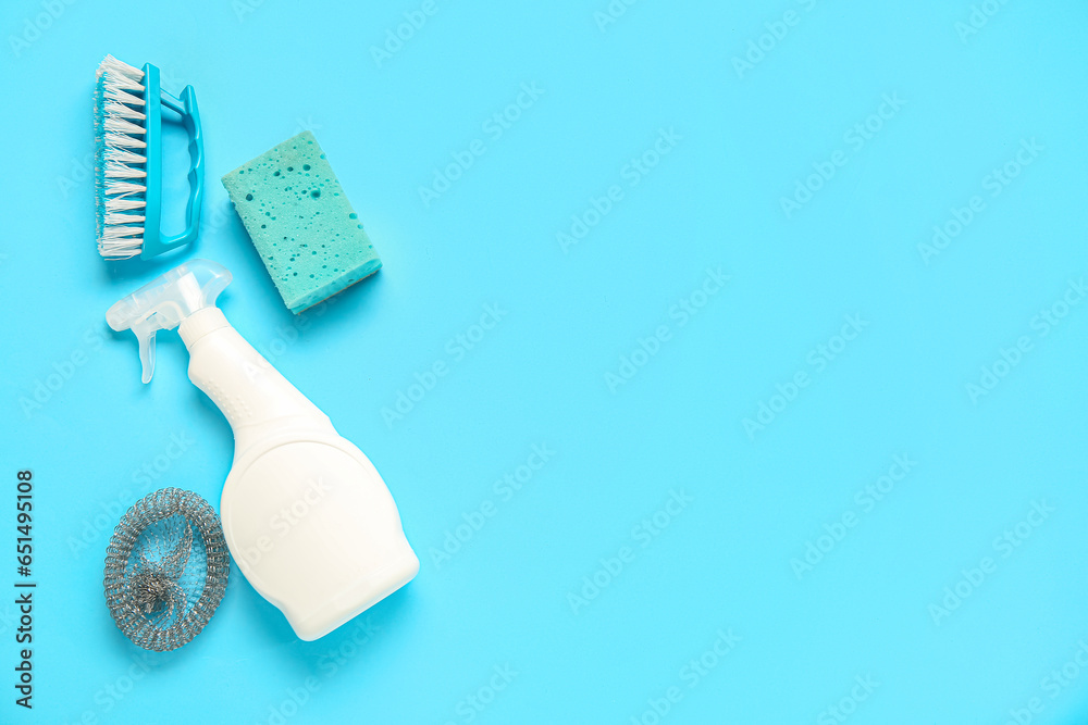 Set of cleaning supplies on blue background