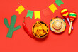 © Pixel-Shot - Composition with Mexican symbols and nachos for Independence Day on red background