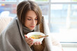 © Pixel-Shot - Ill young woman eating chicken soup at home, closeup