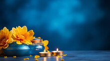 Happy Diwali. Diya Oil Lamps And Yellow Flowers On Blue Background