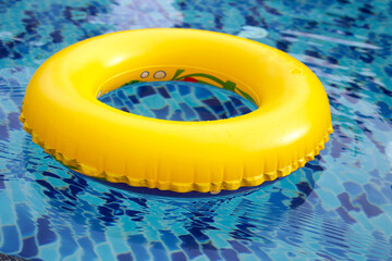 Wall Mural - Swimming pool with yellow inflatable ring.