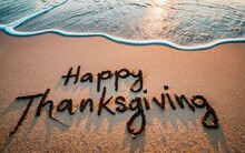 Happy Thanksgiving Written On Sandy Beach Concept. Holiday Greeting Concept.