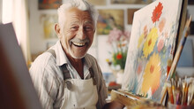 Smiling Old Artist Sitting In Front Of An Easel In His Studio