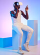 © Talia Mdlungu/peopleimages.com - VR, metaverse and game with man in studio with gaming, virtual reality and esport with 3d. Blue background, cyber and futuristic streaming with headset and video game with technology and media