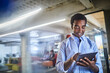 © Geber86 - Young African American man using the tablet in a company office