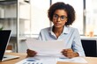 © Anatolii - african american woman doing paperwork in office