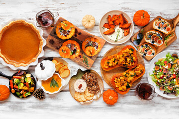 Aufkleber - Delicious autumn meal table scene. Top down view on a white wood background. Stuffed pumpkins and squash, sweet potatoes, appetizers, soup, vegetables and pumpkin pie.
