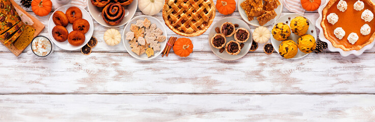 Poster - Autumn desserts top border. Table scene with a collection of traditional fall sweet treats. Above view over a white wood banner background. Copy space.
