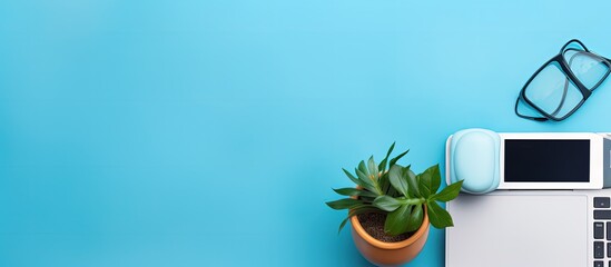 Poster - Modern and orderly workplace with blue desk office equipment computer coffee cup marker pens potted plant black smartphone and notebook