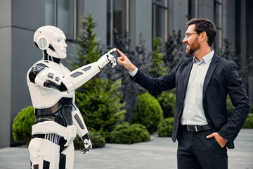 Robot with businessmen on the street near the building