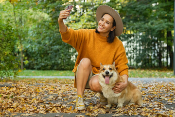 Happy young caucasian young woman walking having fun with her pet