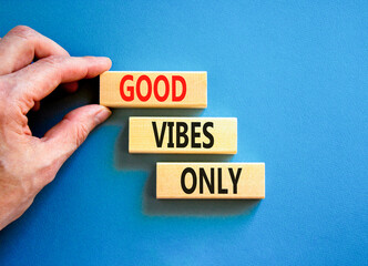 Good vibes only symbol. Concept word Good vibes only on beautiful wooden block. Businessman hand. Beautiful blue table blue background. Business motivational good vibes only concept. Copy space.