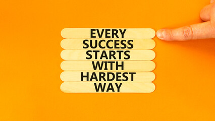 Wall Mural - Success symbol. Concept words Every success starts with hardest way on wooden stick. Beautiful orange background. Businessman hand. Business success and hardest way concept. Copy space.