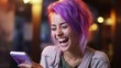 Photo of a woman with purple hair laughing at her cell phone