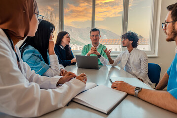 Wall Mural - A medical team of doctors discussing at a meeting in the conference room.