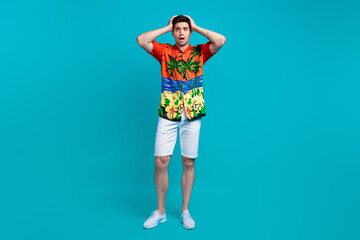 Poster - Full length photo of speechless shocked man dressed print shirt white pants hold arms on head staring isolated on blue color background