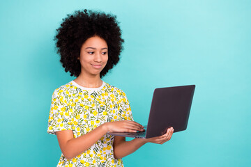 Sticker - Photo portrait of charming young cute daughter holding laptop texting online device for homeschooling isolated on blue color background