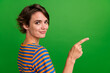 Leinwandbild Motiv Profile photo of lovely positive girl indicate finger empty space proposition isolated on green color background