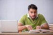 © Elnur - Young male student sitting in front of whiteboard