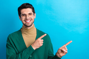 Poster - Photo of cheerful attorney man toothy smile direct fingers empty space ad blank isolated on blue color background