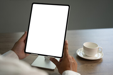 Poster - Digital tablet computer close up man using tablet hands man multitasking with isolated screen