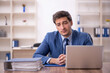 © Elnur - Young male employee and too much work in the office